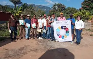 Grupo de personas representando a familias caficultoras , culminando su curso de capacitación