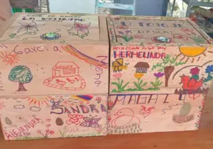 Cajas de ahorro comunitarias decoradas por sus integrantes, utilizadas para fomentar el ahorro colectivo, la organización financiera y el fortalecimiento económico de las familias rurales.