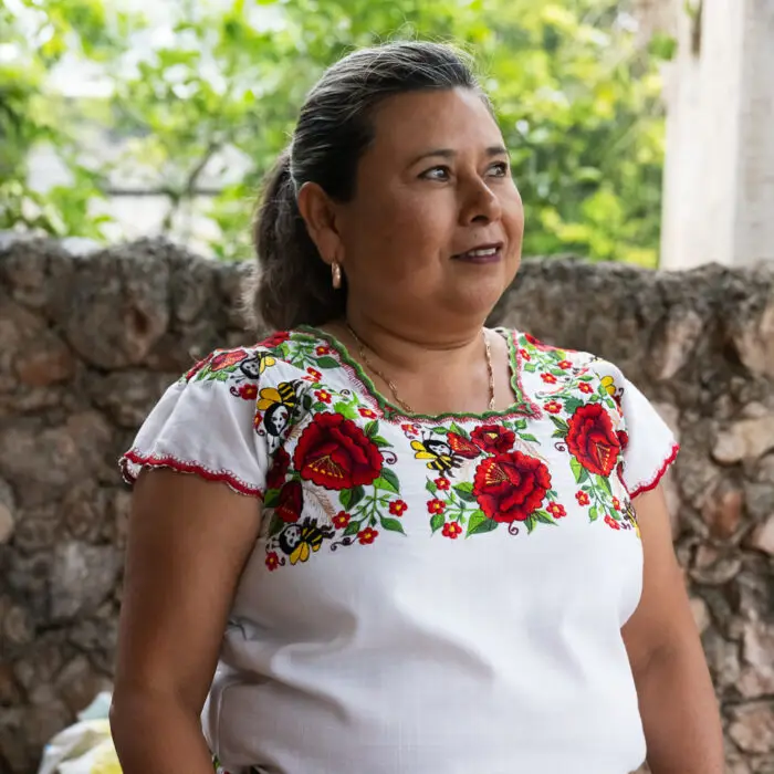 Retrato de una mujer emprendedora participante en un proyecto de producción y comercialización de huevo en comunidades rurales.